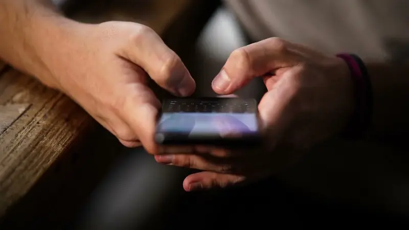A smartphone held in two hands, close up